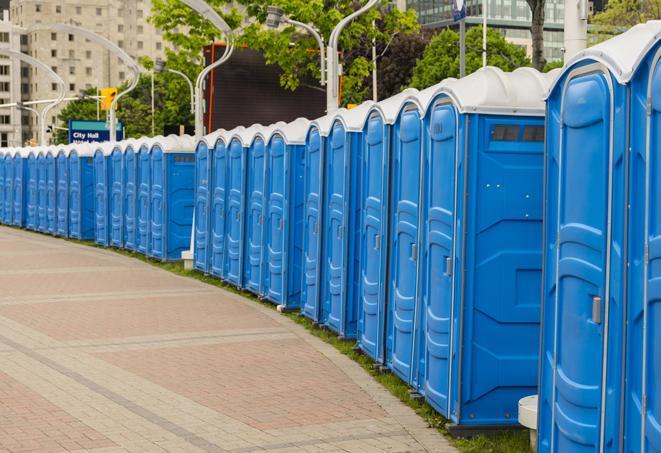 a row of portable restrooms set up for a large athletic event, allowing participants and spectators to easily take care of their needs in Atherton